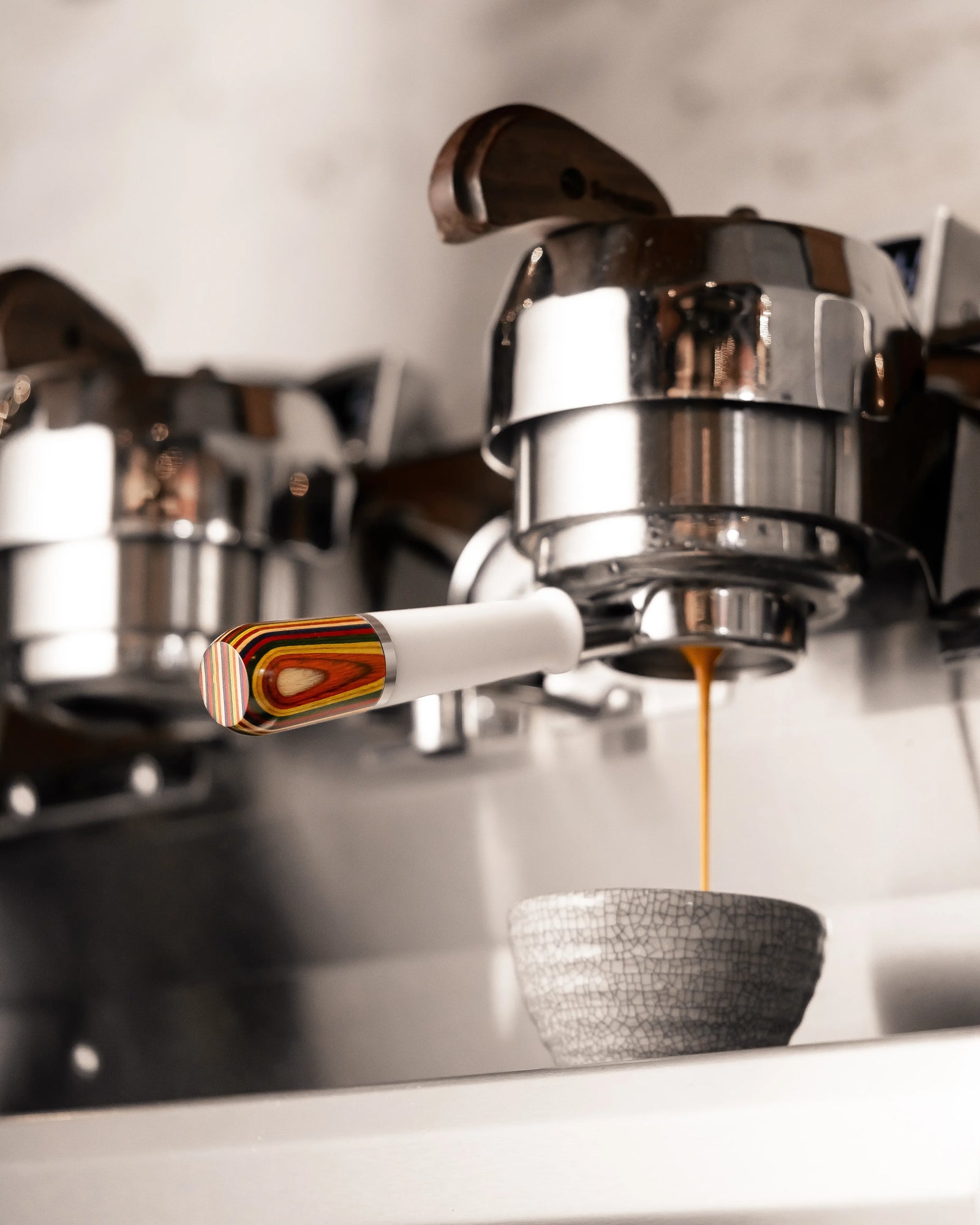 A bottomless portafilter dispensing coffee